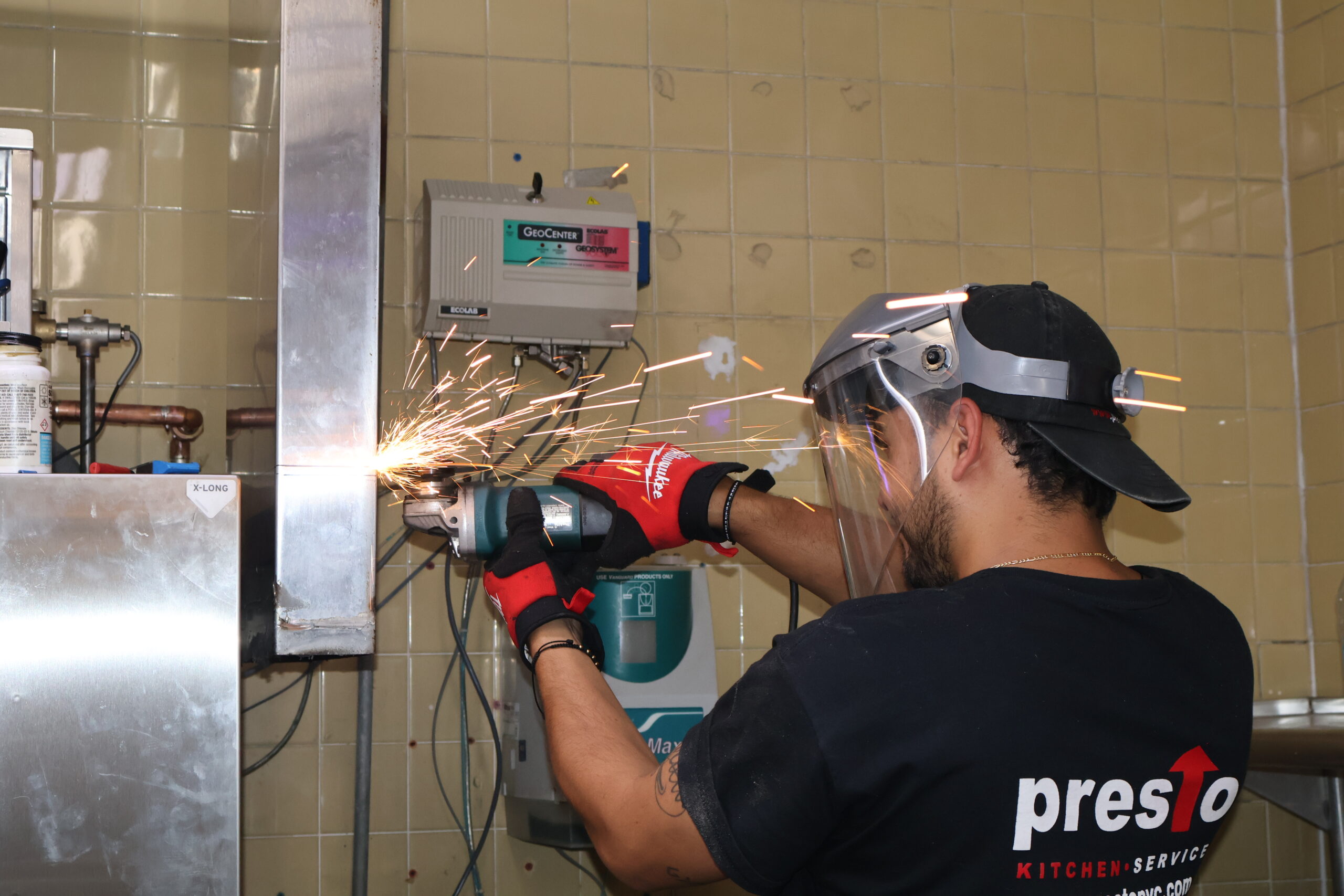 Presto technician working on commercial kitchen equipment